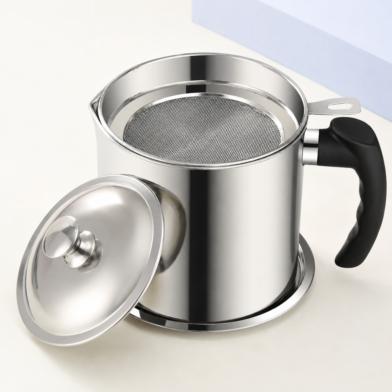 Three-quarter view of stainless steel cooking oil filter pot and fine mesh strainer