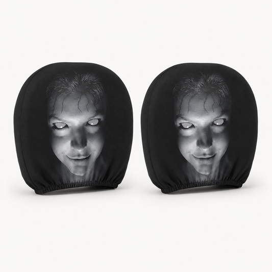 Two Pione ScareSeat black horror face car headrest covers on a warm white background